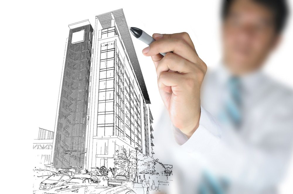 Man drawing tall building design