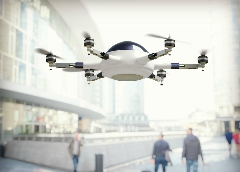 white drone in flight in public place